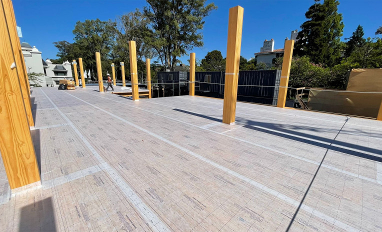 Mass timber construction site with self-adhesive breathable membrane applied on CLT floor for timber protection on site and moisture control. 