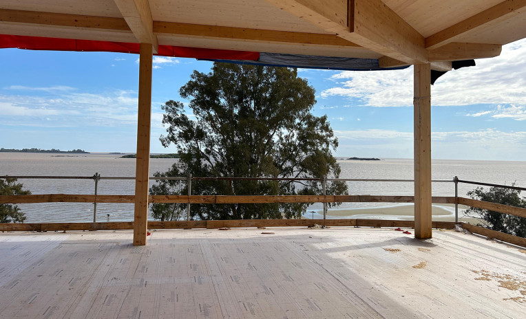 Mass timber structure under construction with CLT floor overlooking Río de la Plata, Uruguay