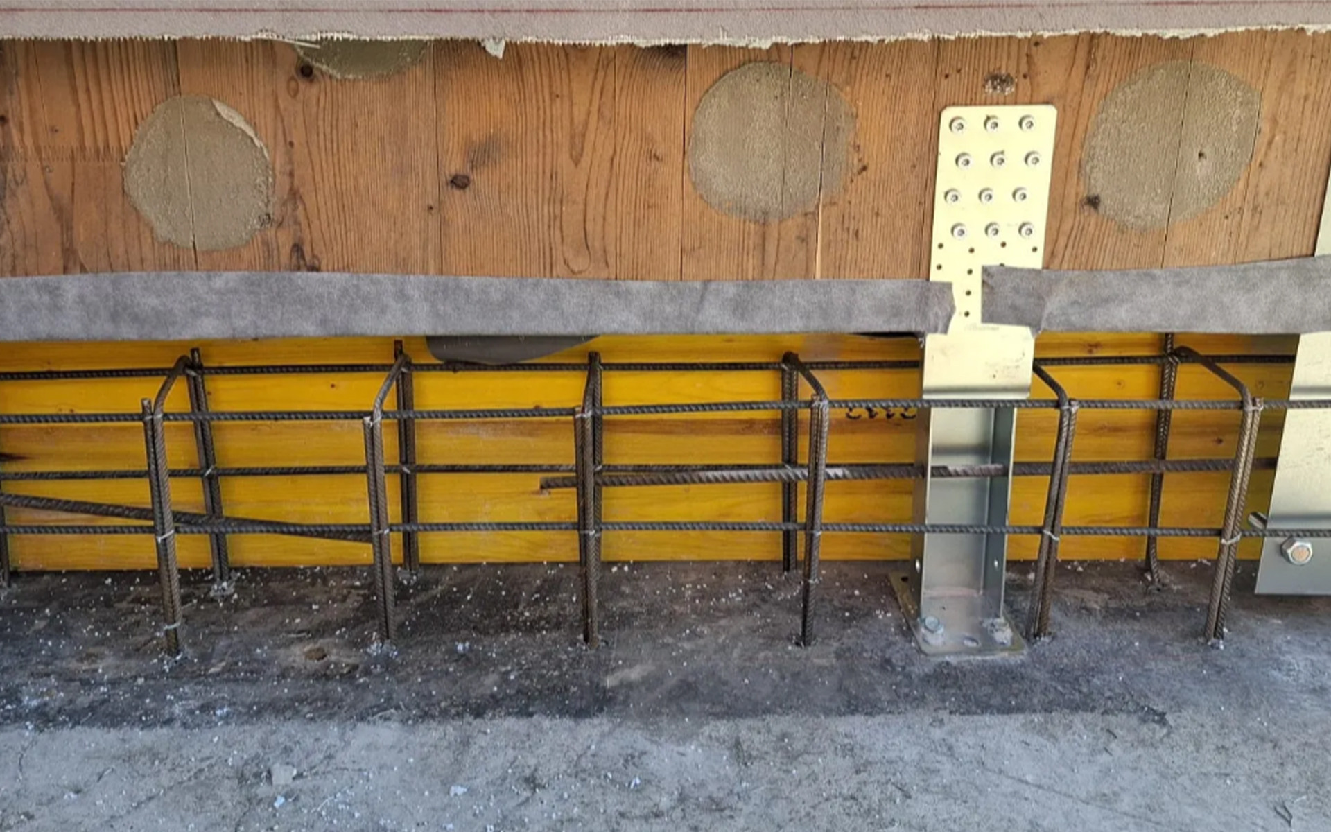 X-LAM structural retrofit detail with UP LIFT system, base connection reinforcement and concrete foundation preparation